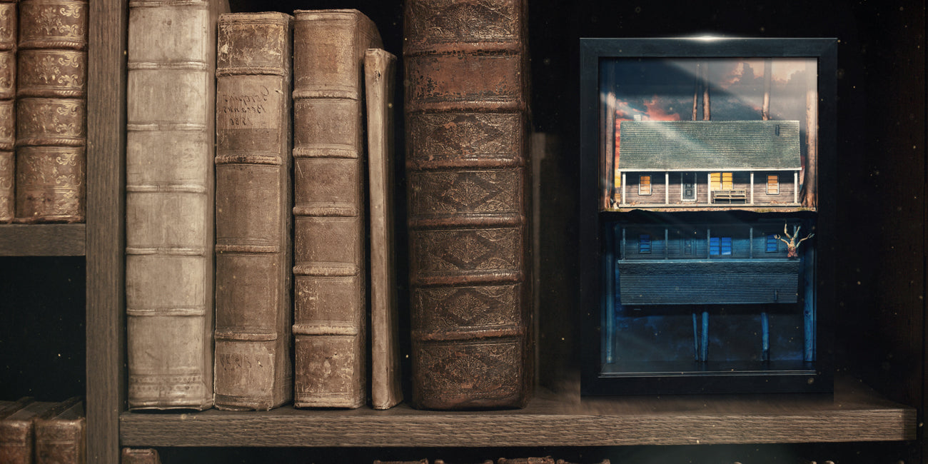 A book shelf with a framed house replica. The Grim Reliquary logo sits on top.